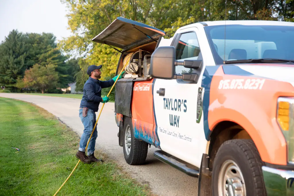Taylor's Way truck and lawn expert on a customer's lawn