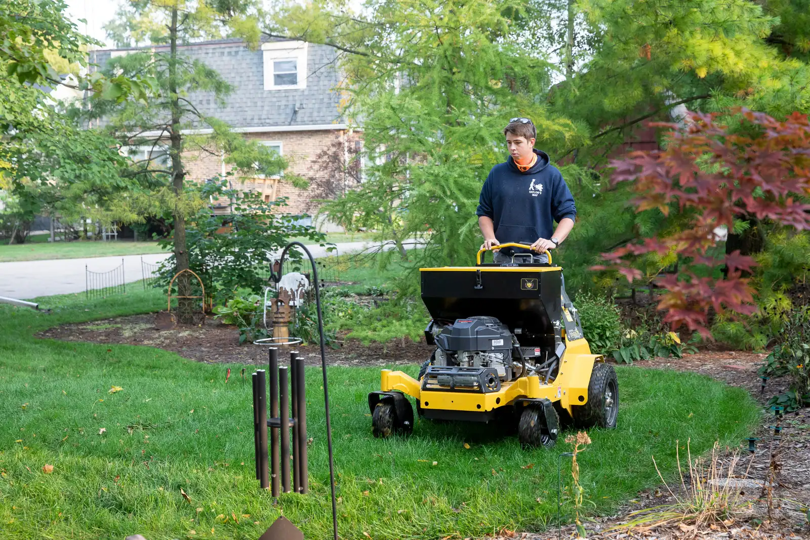 Taylor's Way crew member running aeration and seeding equipment